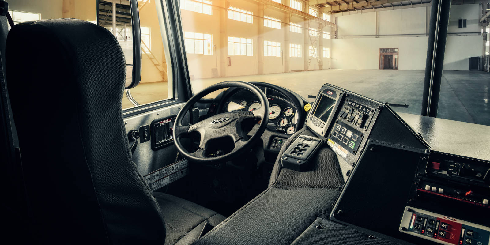 View of a Pierce Mfg fire trucks driver area, including high visibility windshield and saftey electronics